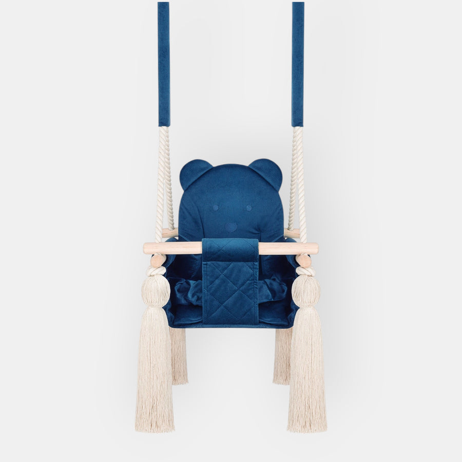 Kinderschaukel für Zuhause Marineblau in der Vorderansicht mit gesteppter Sitzfläche, Holzstange und Quasten